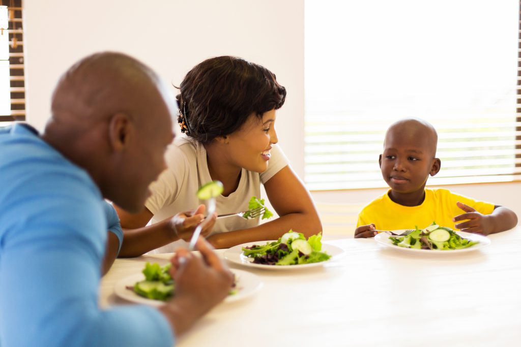 african family enjoying a healthy meal together