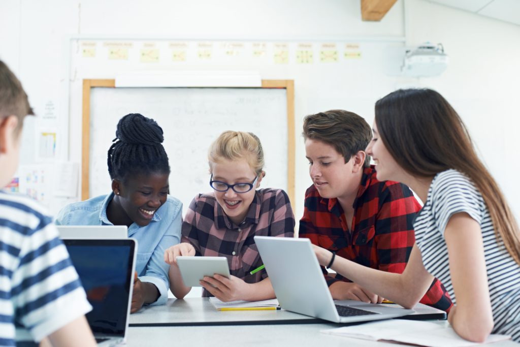 Group of five students working together on a project