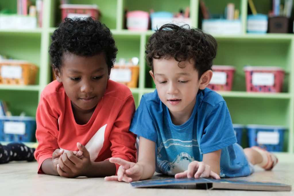Two elementary boys looking at a book
