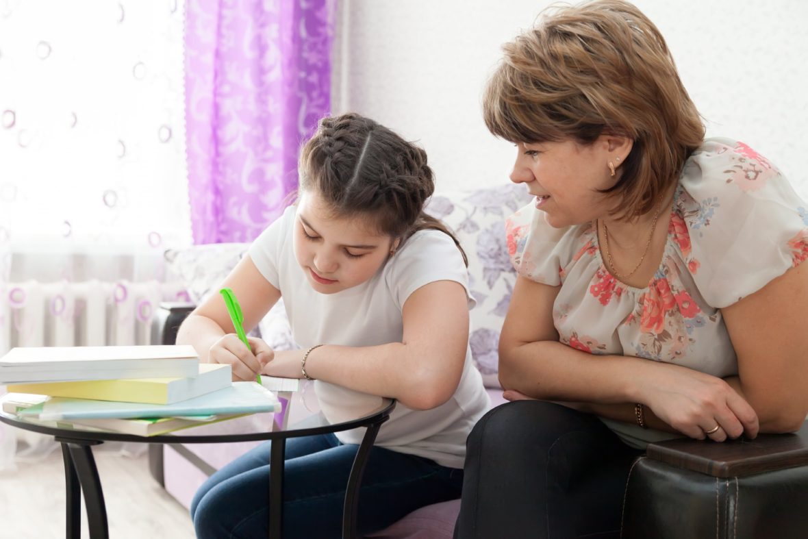 A mother and daughter work on homework.