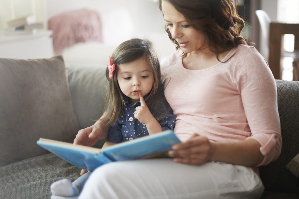 Mother reading to young toddler