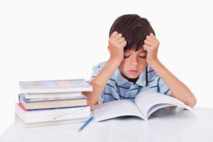 Little boy struggling with school work