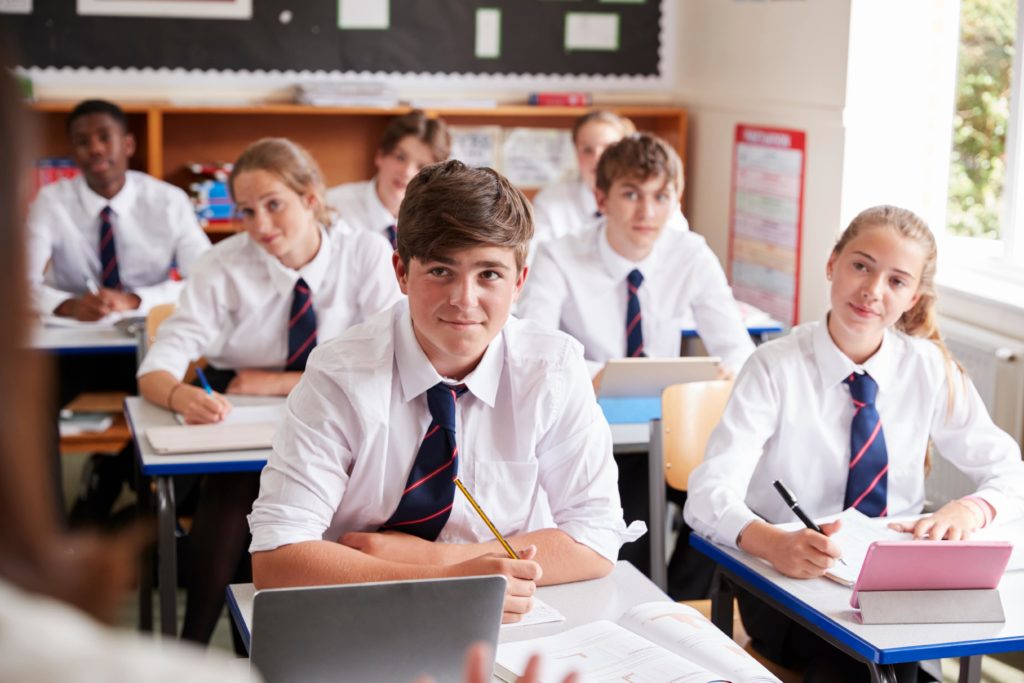 Students listening to their teacher in the classroom