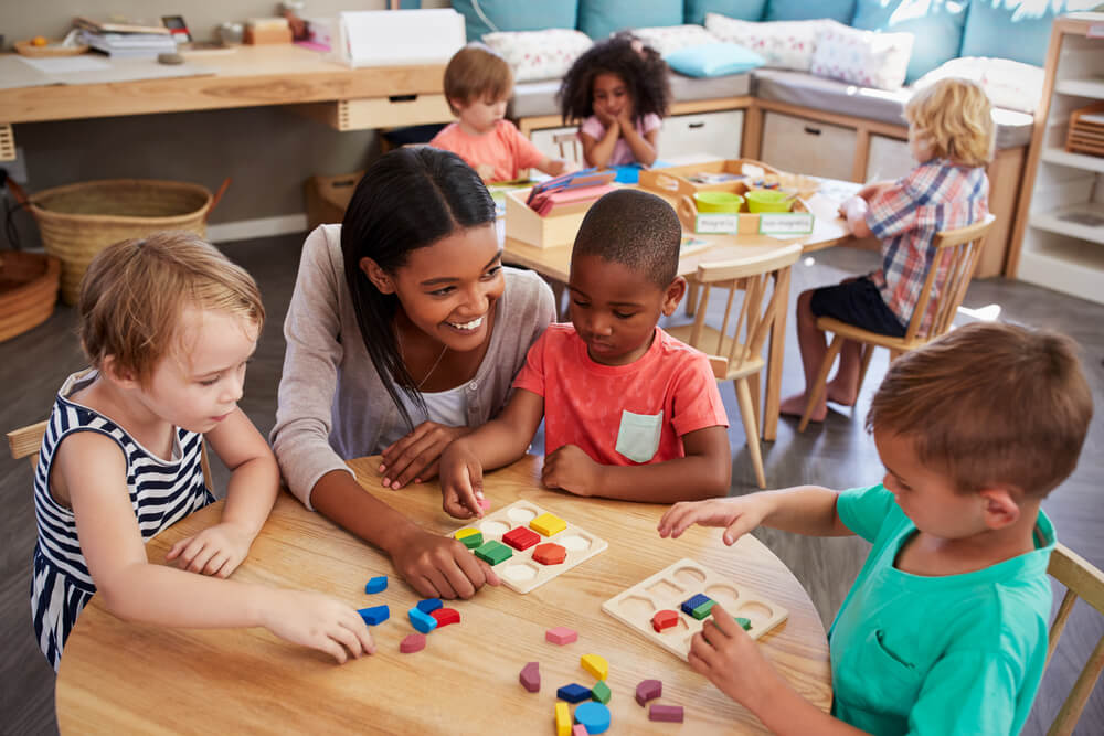 Teacher working with preschool students in the classroom