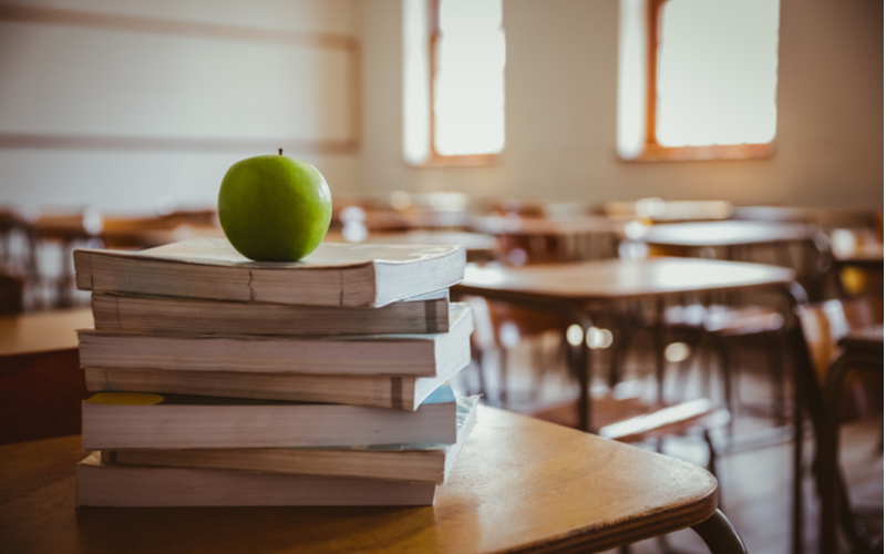 apple on top of school books St. Cecelia Catholic School Back to School Parent’s Guide