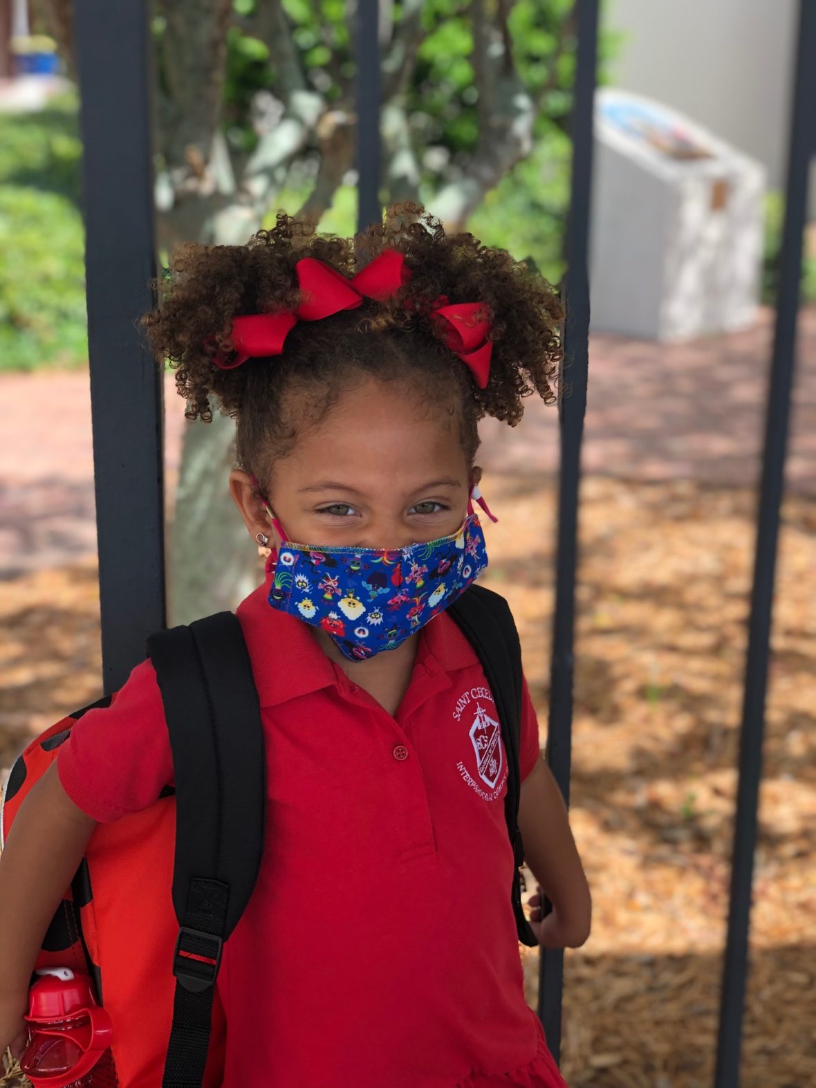 Elementary school girl wearing a colorful mask