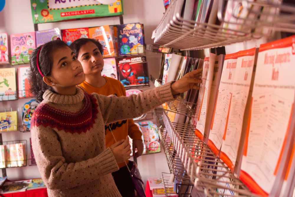 Two young girls attending a book fair