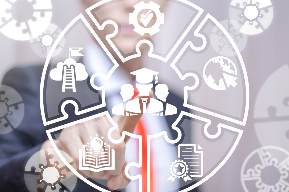 Man in suit pointing at international Baccalaureate Program symbols