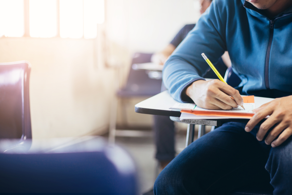 student writing at desk