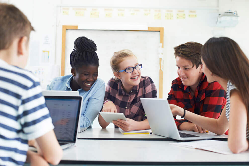 A group of middle school students on computers